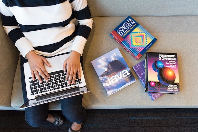 A developer writing code on a laptop